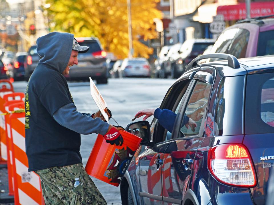 Homeless Veterans Awareness Campaign volunteer Lyle Lambert accepts a donation on Cumberland St. Friday afternoon. The campaign has veterans and friends become voluntarily homeless for more than 30 hours to raise awareness and financial support for homeless vets.