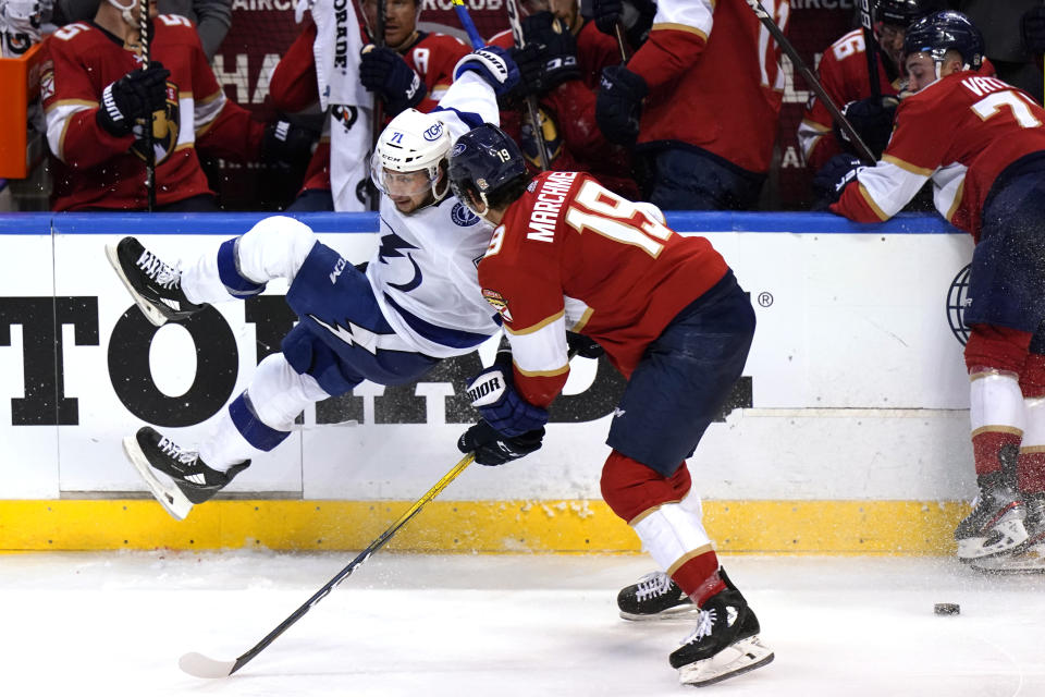 Tampa Bay Lightning center Anthony Cirelli (71) is sent to the boards while going for the puck against Florida Panthers left wing Mason Marchment (19) during the third period in Game 2 of an NHL hockey Stanley Cup first-round playoff series Tuesday, May 18, 2021, in Sunrise, Fla. (AP Photo/Lynne Sladky)