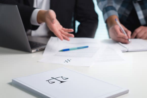 Two people looking at legal documents