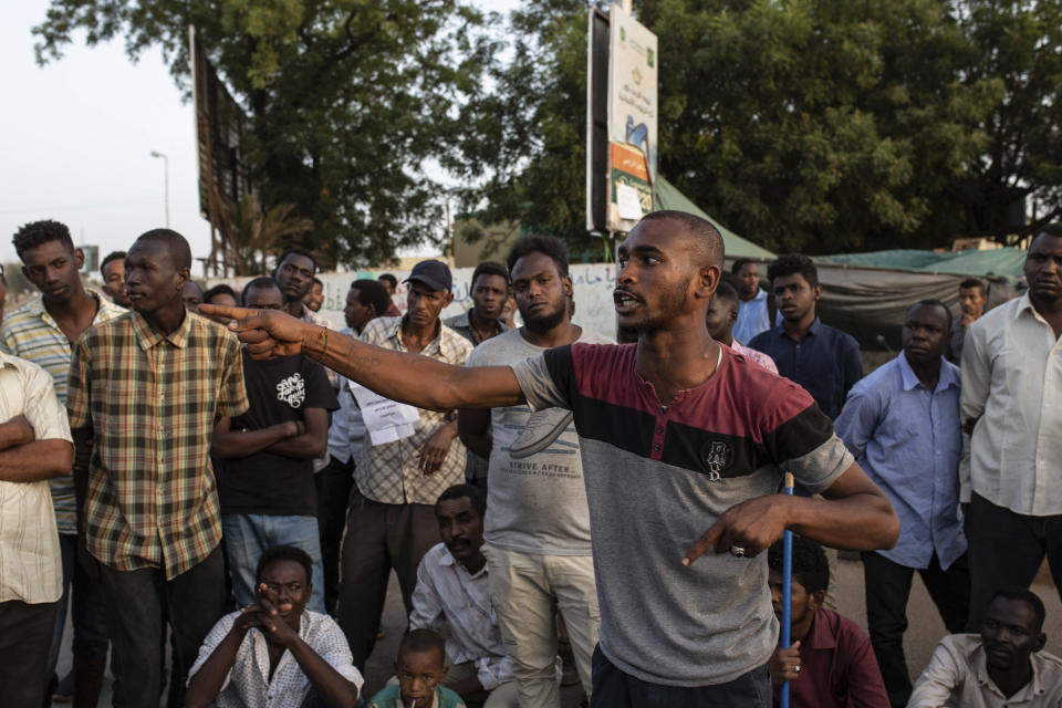 A protesters gives a speech at the sit-in inside the Armed Forces Square, in Khartoum, Sudan, Wednesday, April 17, 2019. A Sudanese official and a former minister said the military has transferred ousted President Omar al-Bashir to the city's Kopar Prison in Khartoum. The move came after organizers of the street protests demanded the military move al-Bashir to an official prison. (AP Photos/Salih Basheer)