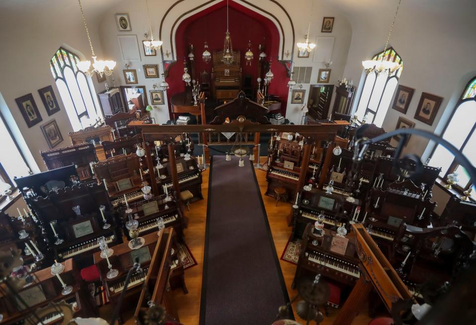 Michael Kennelly has about 50 pump organs. He's arranged them to sit where the pews were located when the church he now owns was Grace Baptist Church.