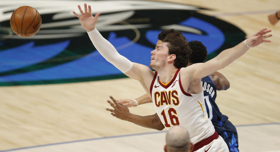 Cleveland Cavaliers forward Cedi Osman (16) reaches for the ball against Dallas Mavericks guard Josh Richardson (0) during the first half of an NBA basketball game, Friday, May 7, 2021, in Dallas. (AP Photo/Brandon Wade)