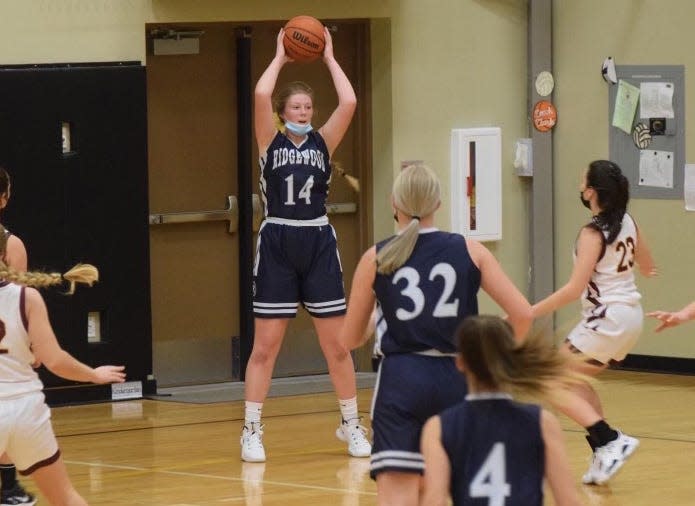 Ridgewood senior Hannah Maher looks for an open teammate in a game this winter. Maher will continue her basketball career playing for Black Hawk.