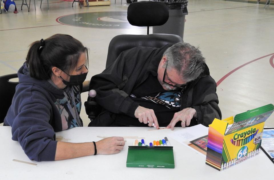 Ron Gianni does a coloring craft with Dilisha Fry, a direct support professional, at Echoing Hills Village. DSPs fill a variety of needs for developmentally disable residents at the facility and others like it across Ohio. As most patients have Medicaid, management of such facility are asking the state for an increase in funding to help pay workers.