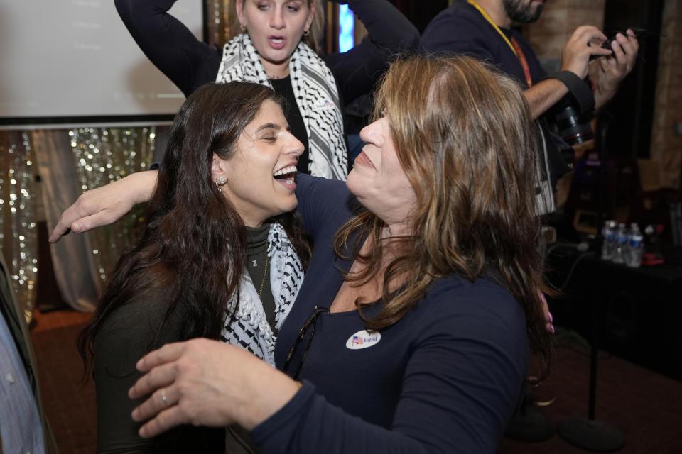 Lexis Zeidan, left, spokesperson for Listen to Michigan, the group running an "uncommitted" campaign, hugs a supporter during an election night gathering, Tuesday, Feb. 27, 2024, in Dearborn, Mich. Democrats are closely watching the results of the “uncommitted” vote, which grassroots organizers have been pushing in Michigan as a way to register objections over Biden’s handling of the war in Gaza. (AP Photo/Carlos Osorio)