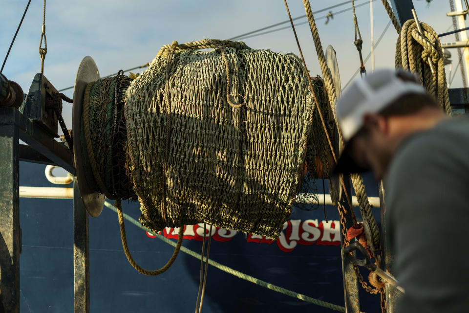 A fishing net is stored aboard the Sabrina Marina as Anthony Lucia installs a camera on captain Al Cottone's boat in Gloucester, Mass., May 11, 2022. A bevy of companies is installing high-resolution cameras on U.S. fishing boats to replace scarce in-person observers and meet new federal mandates aimed at protecting dwindling fish stocks. But taking the technology beyond U.S. waters, where the vast majority of seafood consumed in the U.S. is caught, is a steep challenge. (AP Photo/David Goldman)