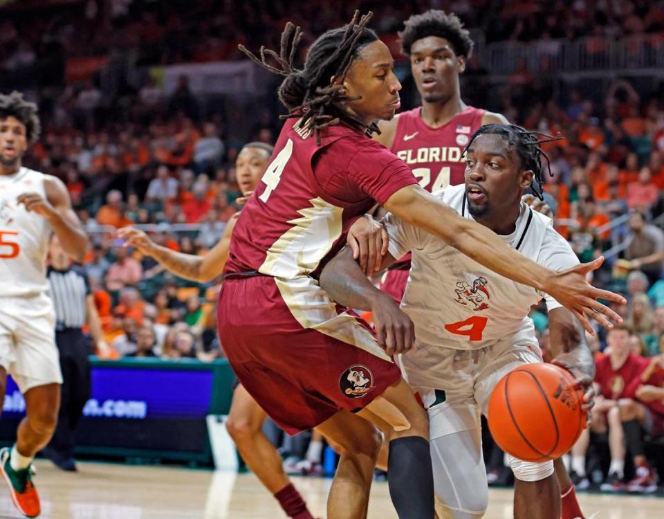 Miami Hurricanes guard Bensley Joseph (4) looks to pass as Florida State Seminoles guard Caleb Mills (4) defends in the first half at the Watsco Center in Coral Gables, Florida on Saturday, February 25, 2023.