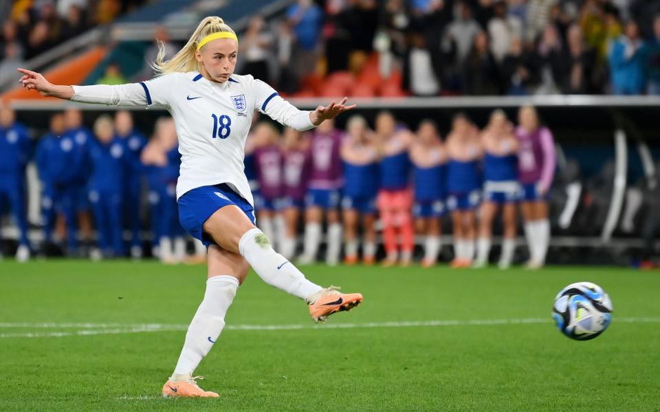 Chloe Kelly of England scores her team's fifth and winning penalty with a poerful right-foot shot