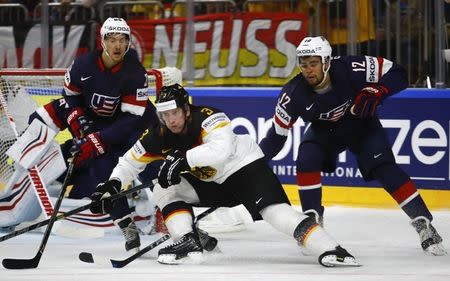 FILE PHOTO: Ice Hockey - 2017 IIHF World Championship - Group A - USA v Germany - Cologne, Germany - 5/5/17 - Jordan Greenway and Danny Dekeyser of the U.S. in action against Justin Krueger of Germany. REUTERS/Wolfgang Rattay