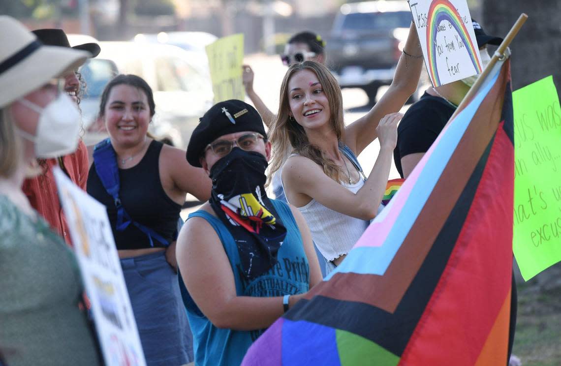 Protesters laugh among each others they gather against he sermon A Biblical View of Sexuality outside The Well Community Church-North Campus in north Fresno Thursday, Aug. 18, 2022. Protesters said the sermon promotes anti-LGBTQ sentiment.
