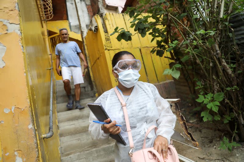 A doctor wearing a protective mask walks after an interview in the low-income neighborhood of Las Mayas, as cases rise amid the coronavirus disease (COVID-19) outbreak, in Caracas