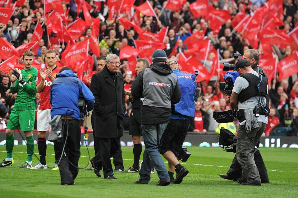 Manchester United manager Sir Alex Ferguson emerges from a guard of honour before his last home match in charge of the club