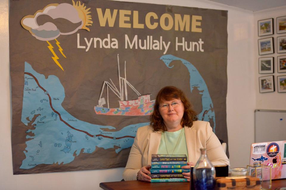 Lynda Mullaly Hunt is a local Cape Cod author. She was photographed at her home office. The art behind her was made by a group of school children from Missouri.