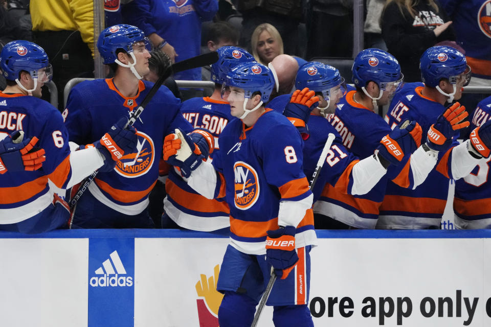 New York Islanders' Noah Dobson (8) celebrates with teammates after scoring a goal during the first period of an NHL hockey game against the Minnesota Wild Tuesday, Nov. 7, 2023, in Elmont, N.Y. (AP Photo/Frank Franklin II)