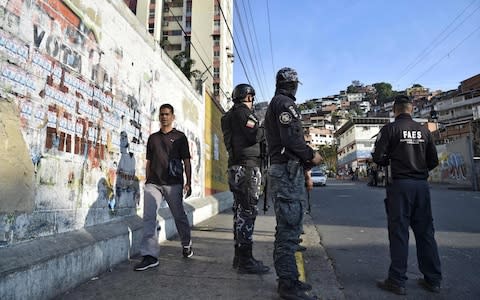 Members of Venezuela's Special Action Forces (FAES) stand at a checkpoint during a security operation in the municipality of El Valle, in Caracas - Credit: AFP