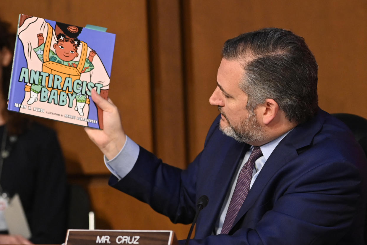 Sen. Ted Cruz holds the book 