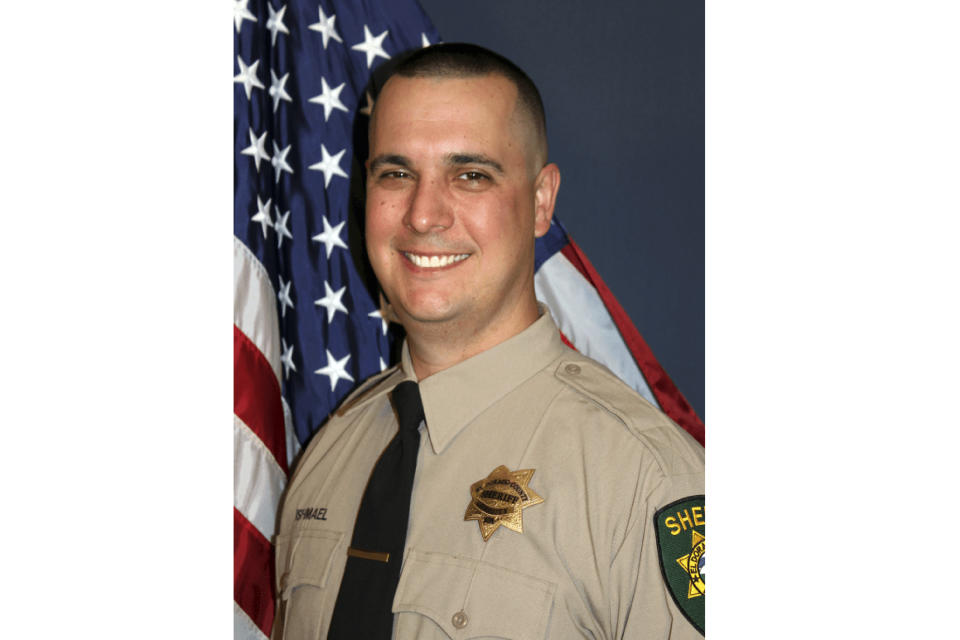 This undated photo provided by the El Dorado County Sheriff's Office shows Deputy Brian Ishmael. The Sheriff's office says Ishmael was fatally shot early Wednesday, Oct. 23, 2019 in the Sierra Nevada Foothills community of Somerset, Calif., and a ride-along passenger with him was injured. An office statement says two men were taken into custody but the scene about 45 miles east of Sacramento remains active. (El Dorado County Sheriff's Office via AP)