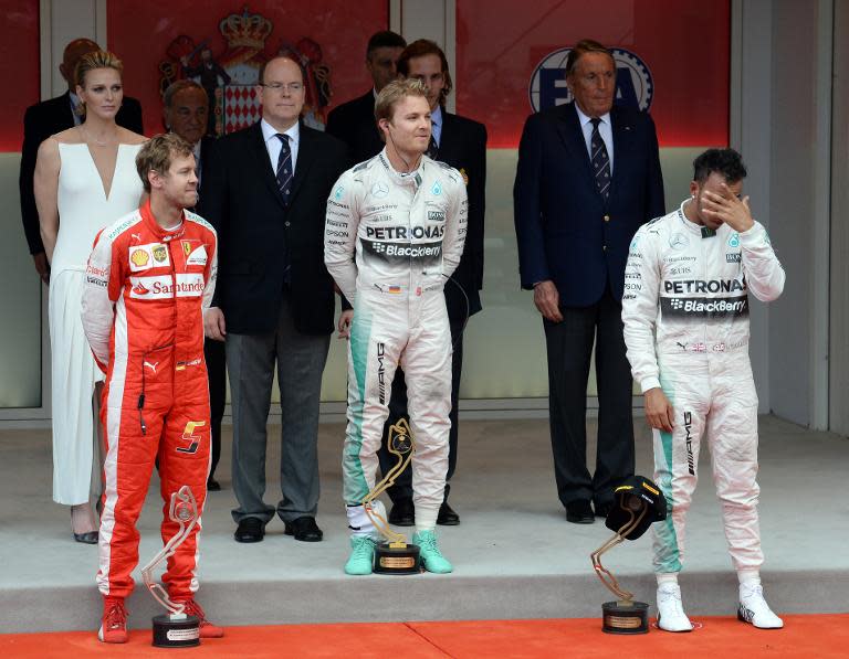 Nico Rosberg (C) tops the podium for Mercedes after the Grand Prix in Monaco on May 24, 2015, with Ferrari's second-placed Sebastian Vettel (L) and third-placed Lewis Hamilton, also with Mercedes