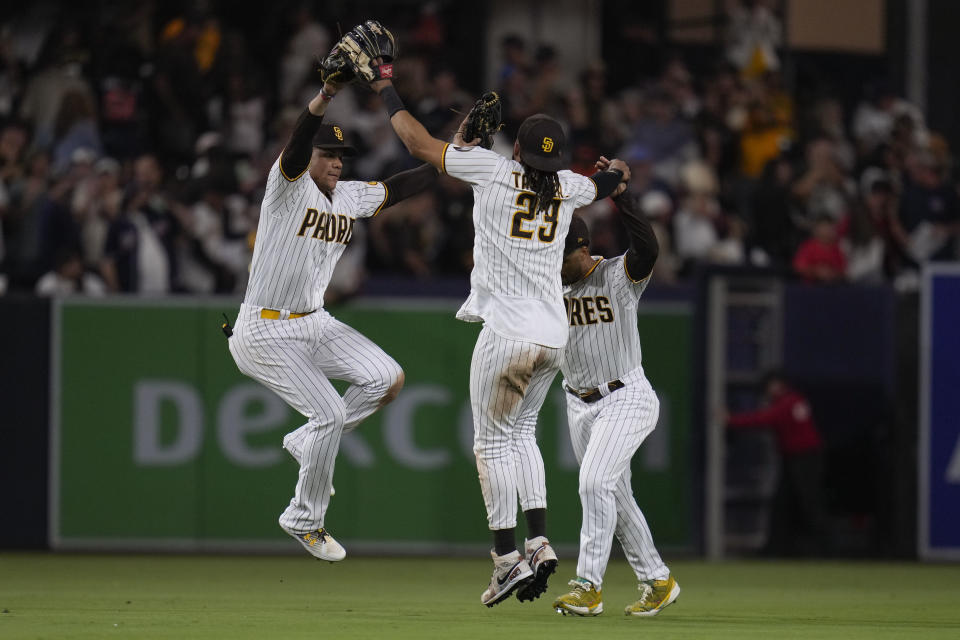 San Diego Padres left fielder Juan Soto, left, celebrates with right fielder Fernando Tatis Jr., center, and center fielder Trent Grisham, right, after the Padres defeated the Baltimore Orioles 5-2 in a baseball game Wednesday, Aug. 16, 2023, in San Diego. (AP Photo/Gregory Bull)