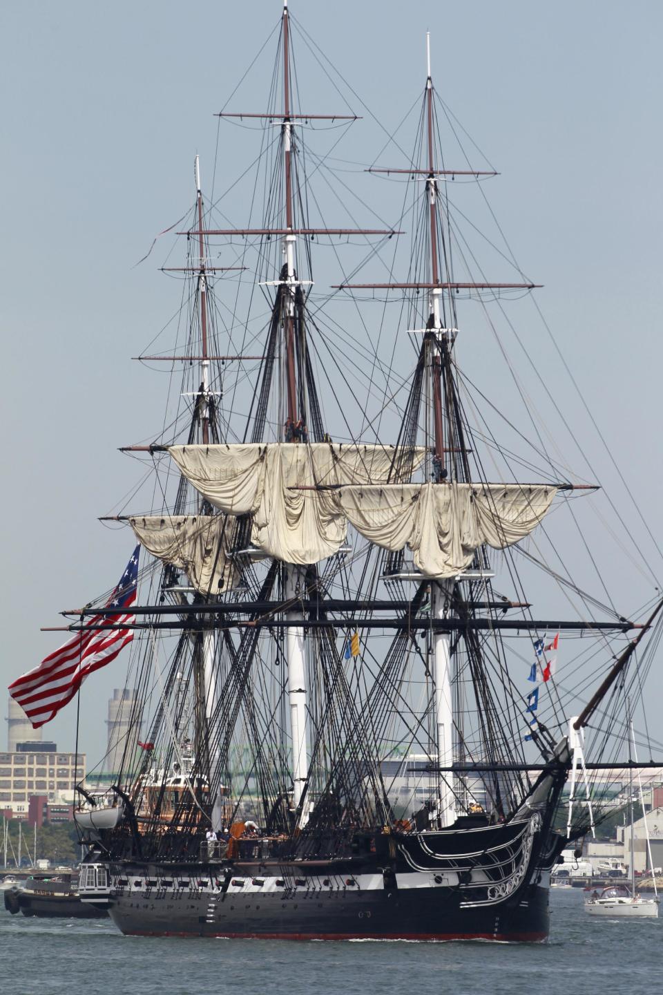 The USS Constitution is escorted by a tugboat in Boston Harbor in Boston, Sunday, Aug. 19, 2012. The USS Constitution, the U.S. Navy's oldest commissioned war ship, sailed under her own power during the event Sunday for the first time since 1997. The sail was held to commemorate the 200th anniversary of the ship's victory over HMS Guerriere in the War of 1812. (AP Photo/Steven Senne)