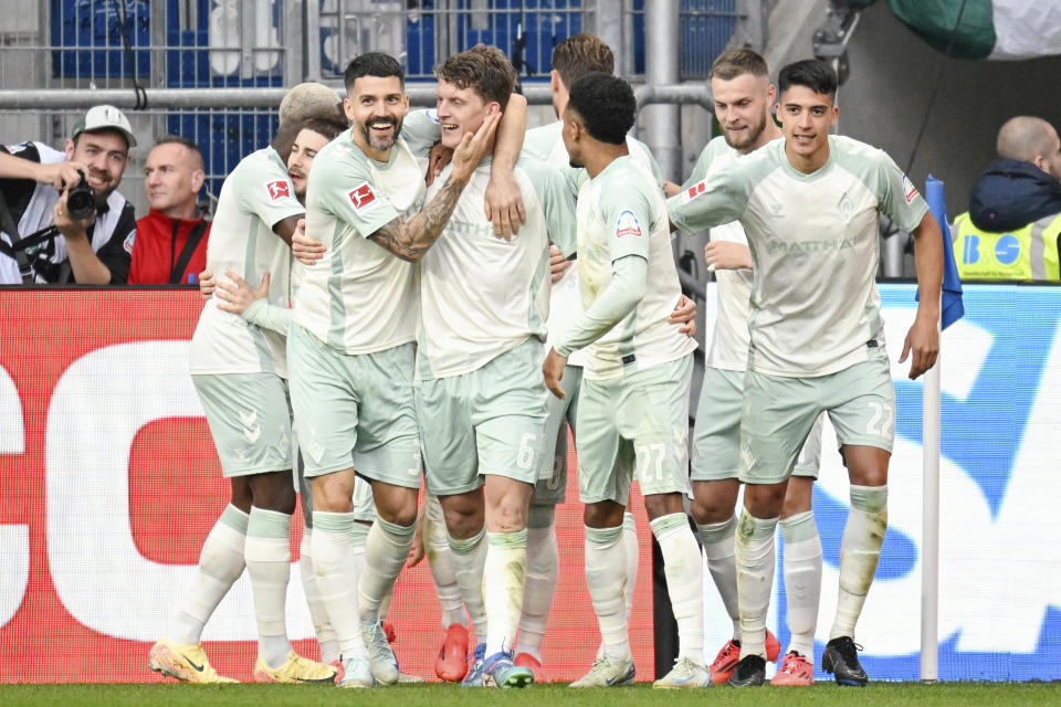 Bremen's Jens Stage, fourth from left, celebrates with teammates after scoring his side's fourth goal during the Bundesliga soccer match between TSG 1899 Hoffenheim and Werder Bremen, at the PreZero Arena in Sinsheim, Germany, Sunday, Sept. 29, 2024. (Uwe Anspach/dpa via AP)