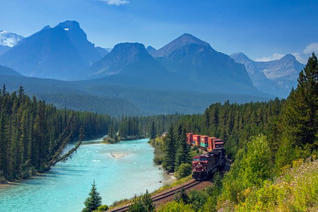 A Canadian Pacific Railway freight train follows the Bow River at Morant's Curve in Banff National Park, Canada. (Photo: Arterra via Getty Images)