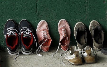 Shoes of Cuban migrants are seen at a temporary shelter in a school in the town of La Cruz near the border between Costa Rica and Nicaragua, November 16, 2015. REUTERS/Juan Carlos Ulate