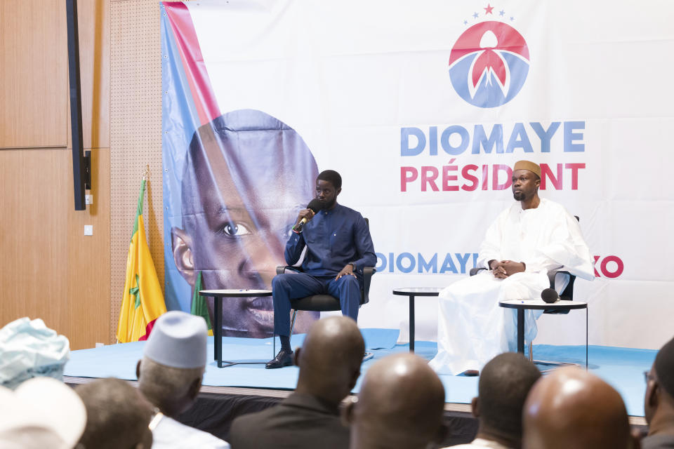 Senegal's top opposition leader Ousmane Sonko, right, and his key ally Bassirou Diomaye Faye address supporters in Dakar, Senegal, Thursday, March 14, 2024. Sonko had been in prison since July 2023 and has fought a prolonged legal battle to run for president in the March 24 election.(AP Photo/Sylvain Cherkaoui)