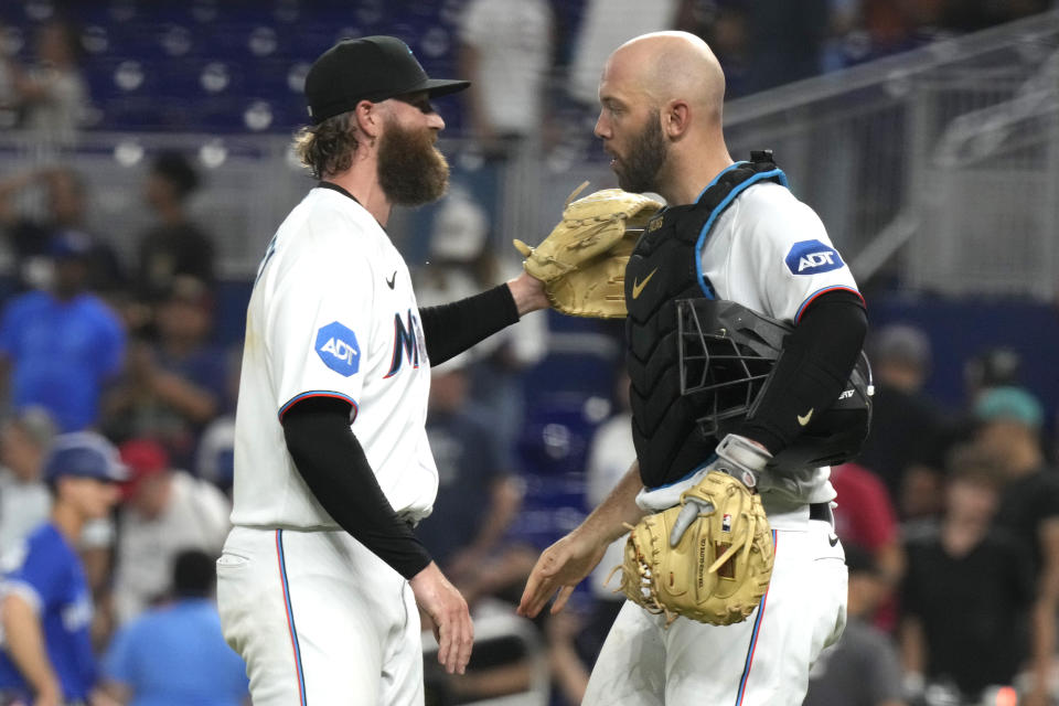 Miami Marlins relief pitcher Archie Bradley, left, congratulates catcher Jacob Stallings after a baseball game against the Toronto Blue Jays, Monday, June 19, 2023, in Miami. (AP Photo/Lynne Sladky)