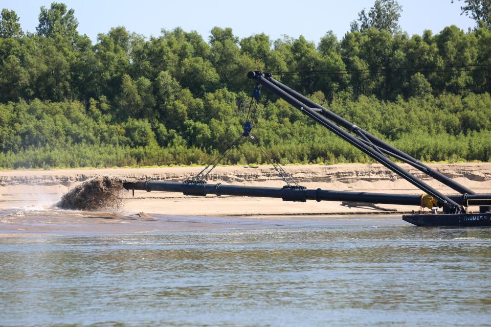 The discharge pipe from the Dredge Potter, a U.S. Army Corps of Engineers vessel, sends dredged sediment onto the Mississippi River shore south of Chester, Illinois.