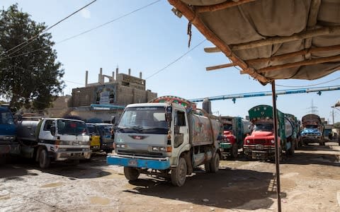 Water tankers line up under the water supply pipe at an illegal hydrant in Karachi’s West District on December 6, 2018 - Credit: Insiya Syed/The Telegraph