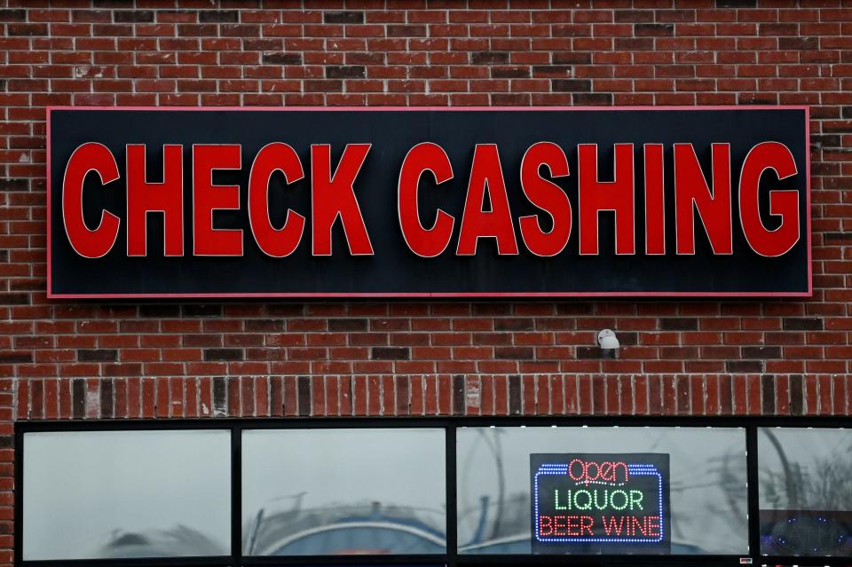 A liquor store that offers check cashing services on Martin Luther King Jr. Boulevard on Tuesday, Dec. 13, 2022, Lansing.