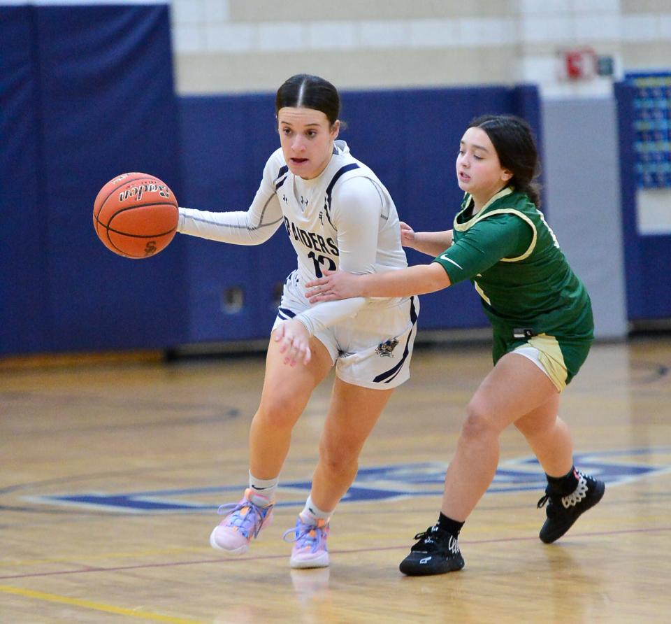 Somerset Berkley’s Audrey Sperling dribbles while being guarded by Greater New Bedford's Olivia Reis.