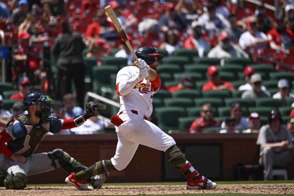 St. Louis Cardinals' Brendan Donovan, right, watches his RBI single in the seventh inning of a baseball game against the Boston Red Sox, Sunday, May 19, 2024, in St. Louis. (AP Photo/Joe Puetz)