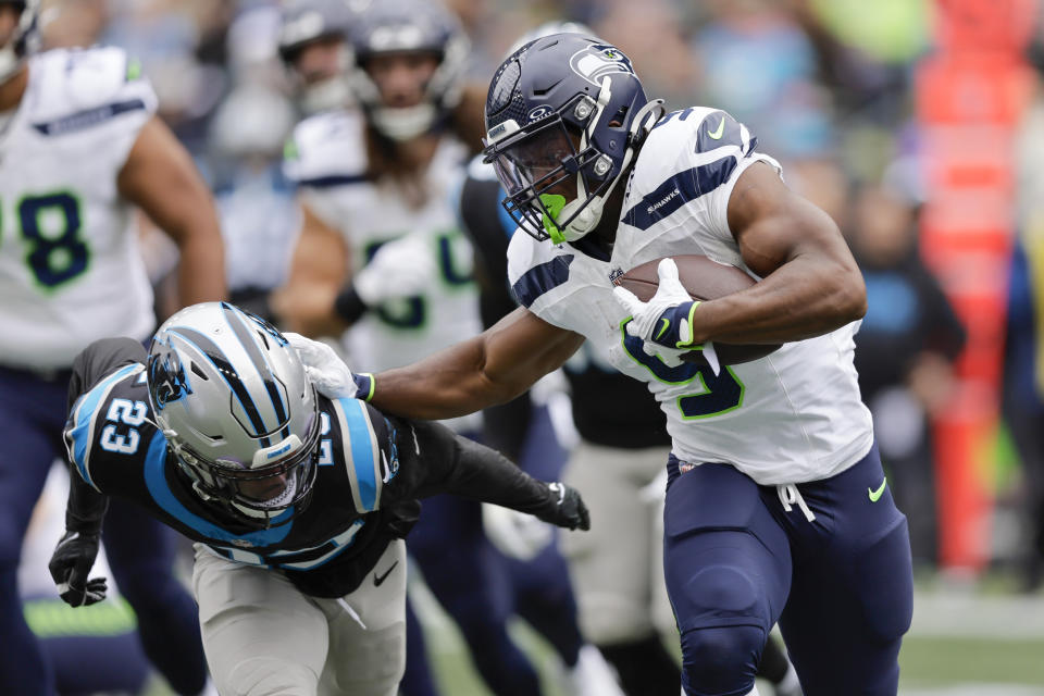 Seattle Seahawks running back Kenneth Walker III runs around Carolina Panthers cornerback CJ Henderson during the first half of an NFL football game Sunday, Sept. 24, 2023, in Seattle. (AP Photo/John Froschauer)