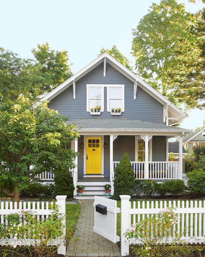 gray home exterior with yellow front door