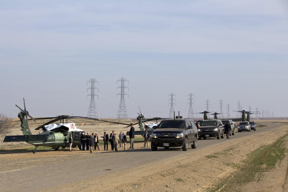 President Barack Obama, gesturing at center of group, arrives to take part in a roundtable with community leaders at San Luis Water Facility in Firebaugh, Calif., Friday, Feb. 14, 2014. (AP Photo/Jacquelyn Martin)