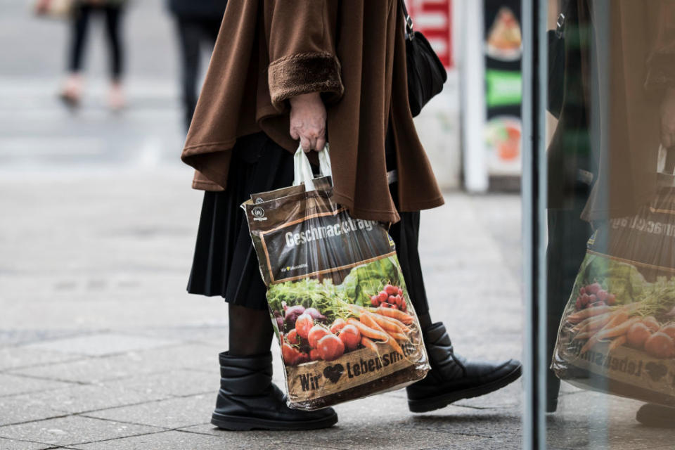 BERLIN, GERMANY - DECEMBER 17: An old woman with a bag of Edeka is pictured on December 17, 2019 in Berlin, Germany. (Photo by Florian Gaertner/Photothek via Getty Images)