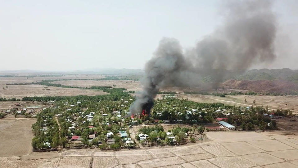 In this photo released by the Myanmar Army, a fire burns May 16, 2020, in the predominantly ethnic Rakhine village of Let Kar in Rakhine State's Mrauk-U township, western Myanmar. The Rakhine areas since January last year has been the scene of bitter armed conflict between the government and the Arakan Army, a guerrilla force of the Rakhine ethnic minority seeking greater autonomy for the state. (Myanmar Army via AP)