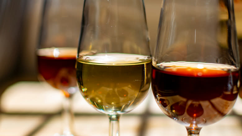 three glasses of different colored fortified wine