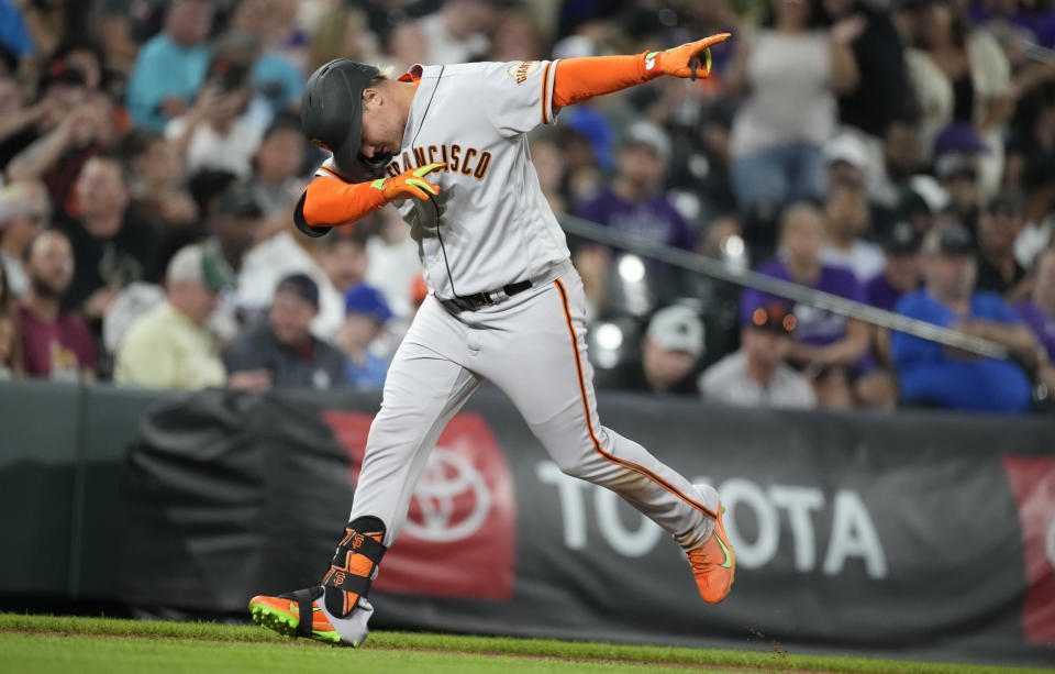 San Francisco Giants' Joc Pederson gestures after hitting a solo home run off Colorado Rockies starting pitcher Jose Urena during the sixth inning of a baseball game Friday, Aug. 19, 2022, in Denver. (AP Photo/David Zalubowski)