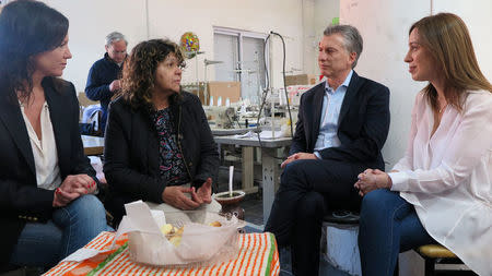 Argentina's President Mauricio Macri, Buenos Aires province governor Maria Eugenia Vidal (R) and Argentina's Minister of Social Development Carolina Stanley (L) talk to Lucila Godoy, president of the Osito Feliz textil cooperative factory in Berazategui, on the outskirts of Buenos Aires, Argentina September 18, 2017. Argentine Presidency/Handout via REUTERS