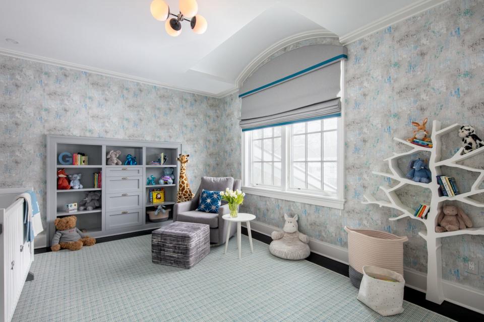 a room with a blue wall and white shelves