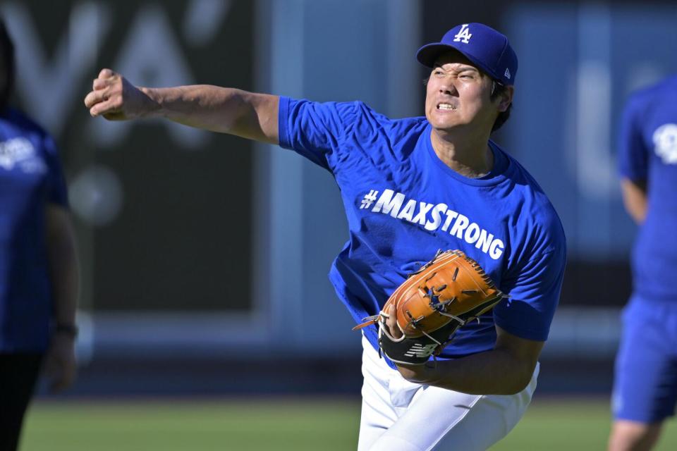 Dodgers' Shohei Ohtani throws in the outfield prior to a game against the Seattle Mariners on August 20.