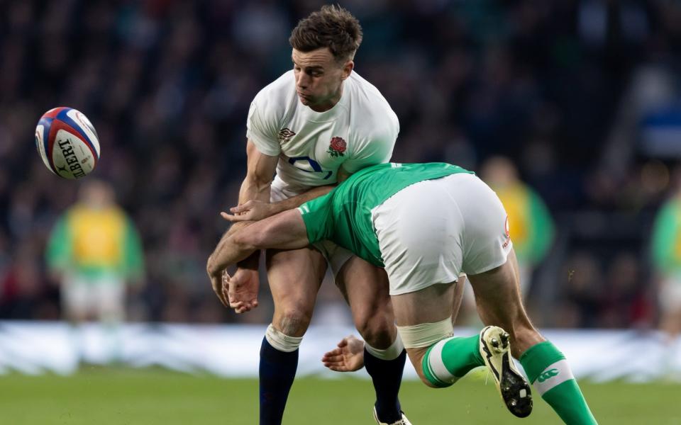 George Ford of England passes the ball as he is tackled by Hugo Keenan of Ireland during the Guinness Six Nations 2024 match between England and Ireland at Twickenham Stadium on March 9, 2024 in London, England