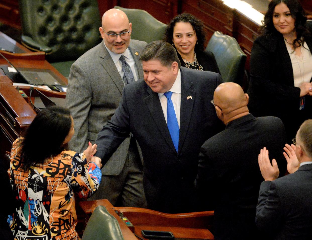 Illinois Gov. JB Pritzker shakes hands as he enters the House chamber for his annual State of the State budget address before the General Assembly Wednesday.