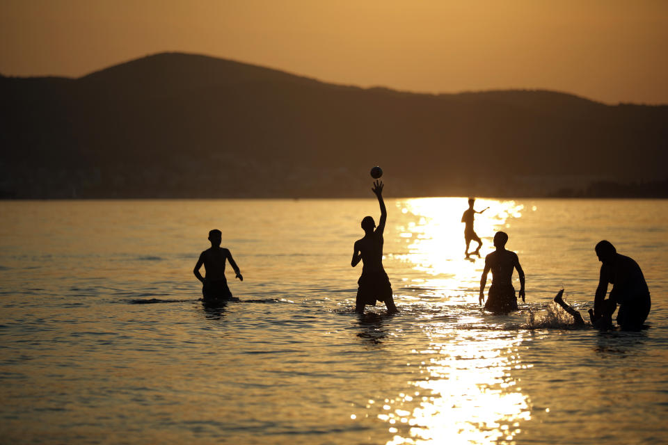 <p>People enjoy the sea during sunset in the outskirts of Izmir, western Turkey, Thursday, Aug. 23, 2018. (AP Photo/Emre Tazegul) </p>