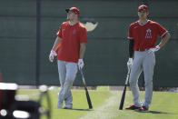 Los Angeles Angels' Mike Trout, left, and Shohei Ohtani watch batting practice during spring training baseball practice, Monday, Feb. 17, 2020, in Tempe, Ariz. (AP Photo/Darron Cummings)