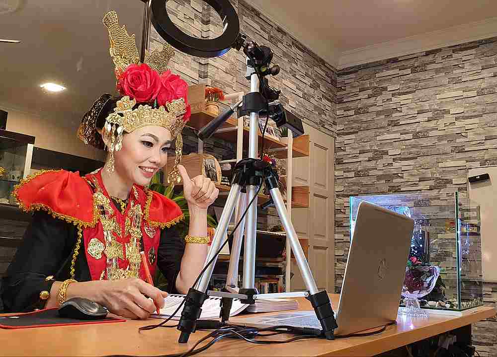 Miri teacher Nancy Maria in her elaborate Melanau bride costume she wore during online class today. — Picture from Facebook/Nancy Maria