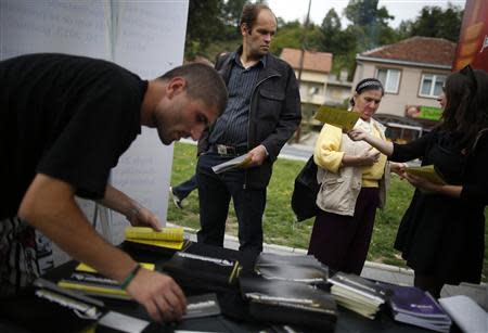 Volunteers hand out leaflets with information about new Bosnia's census in Jablanica, 60 kilometres (37 miles) south of Sarajevo, September 27, 2013. REUTERS/Dado Ruvic